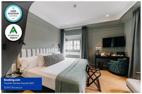 a bedroom with a bed and a tv on a wall at Soho Boutique Colón in Málaga