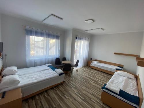 Ένα ή περισσότερα κρεβάτια σε δωμάτιο στο Meduza ośrodek wczasowy