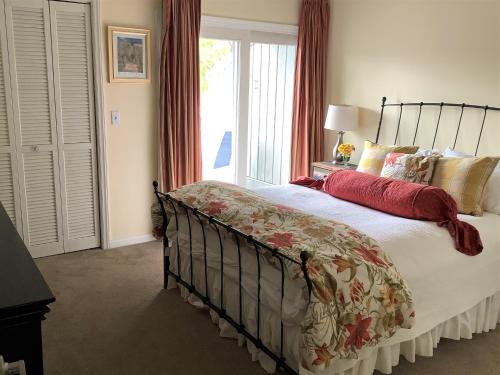 a bedroom with a bed and a large window at Elegant 3 BR 3 BA Wild Dunes Gated Resort Villa with 2 Golf Courses, Beach and Pool in Isle of Palms