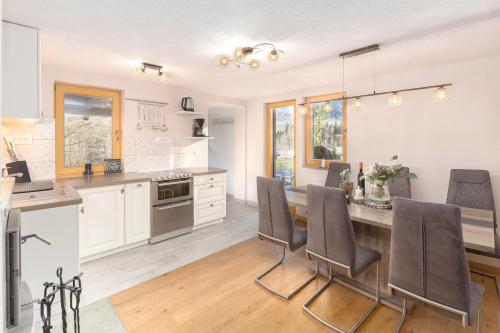 a kitchen with a table and chairs in a room at Bohinj Cottage Pr' Maricki - house in nature with hot tub & sauna in Bohinj