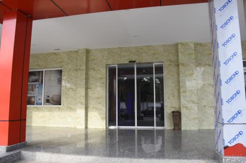 an entrance to a building with a glass door at Hotel Royal Palace in Douala
