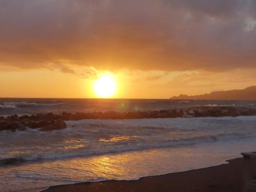 a sunset on the beach with the ocean at Hotel Zia Piera in Chiavari