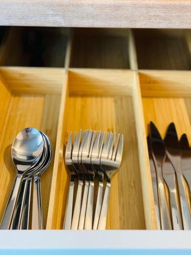 a group of silver forks and spoons in a drawer at Sarah Home in Hunedoara