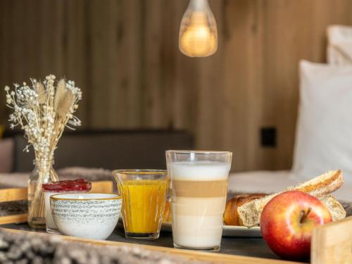 a tray with breakfast foods and drinks on a table at Mercure Valence in Valence