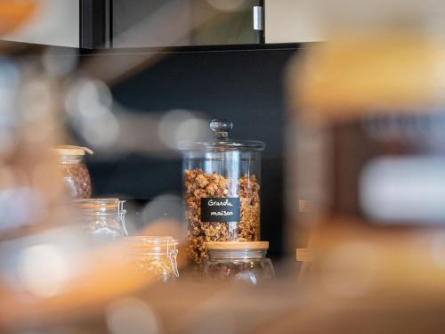 a glass jar filled with nuts on a table at Mercure Valence in Valence