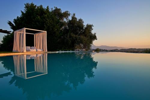 a pool of water with a door in the middle at The Editor's Villa - Member of Spiritual Living Corfu in Virós
