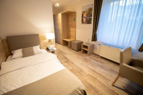 Postel nebo postele na pokoji v ubytování Hotel Fallersleber Spieker