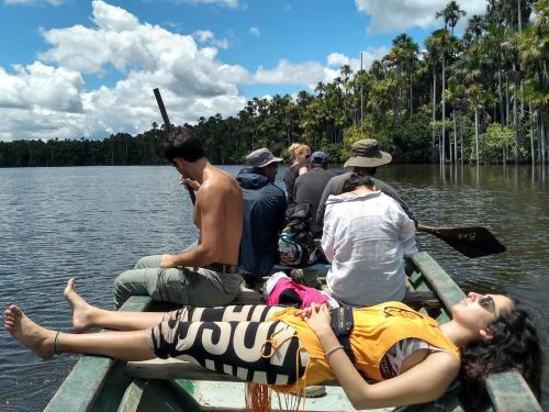a group of people on a boat on the water at Monte Amazonico Lodge in Tambopata