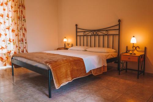 a bedroom with a large bed and two night stands at Dream Drop Studios in Kyparissia