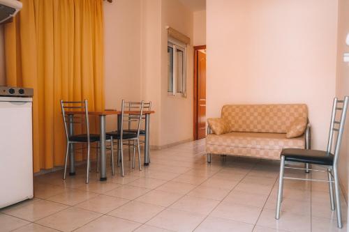 a room with a table and chairs and a couch at Dream Drop Studios in Kyparissia
