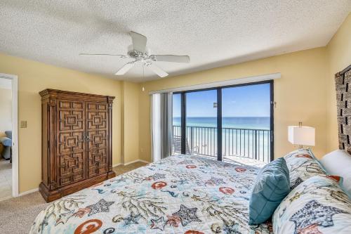 a bedroom with a bed and a view of the ocean at Commodore Resort #707 by Book That Condo in Panama City Beach