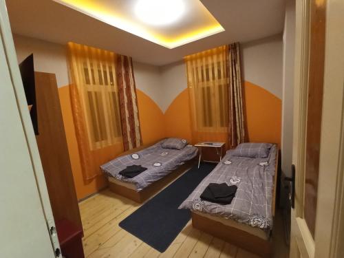 a small room with two beds and a tv at Къща in Gabrovo