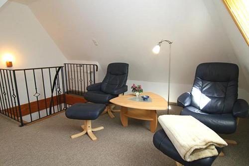 a room with two chairs and a table and a table and two chairs at Haus Gräpel App 4 in Hörnum