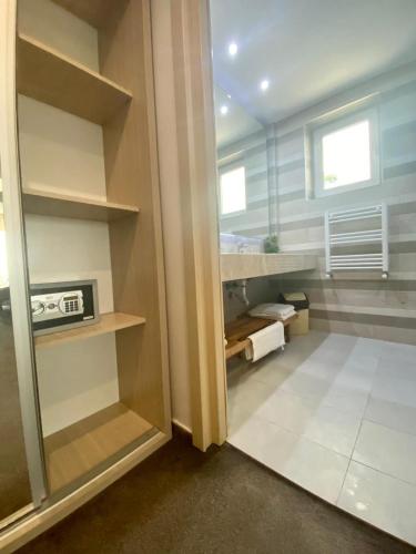 a walk in closet with shelves and a window at Ella by the sea Residence in Mamaia Sat/Năvodari