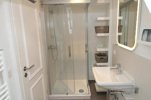 a bathroom with a shower and a sink at Strandperle 03 in Hörnum