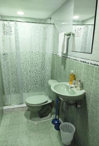 a bathroom with a toilet and a sink at Apartamentos Riohacha in Ríohacha