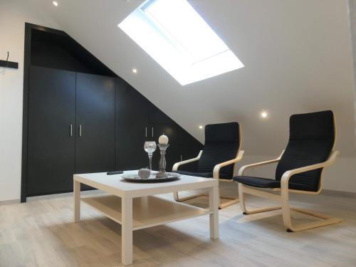 a living room with a table and two chairs at Balade en amoureux au calme in Rochefort