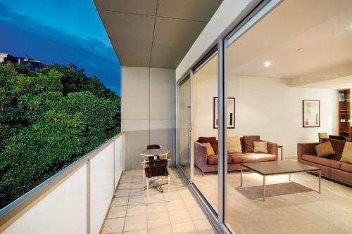 a living room with a couch and a table at Brighton Bay Apartments in Melbourne