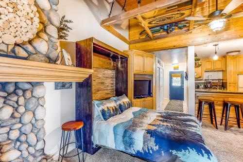 a bedroom with a bed and a stone wall at The Lake House in Shaver Lake