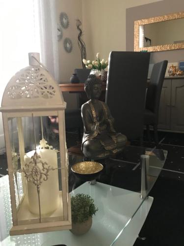 a statue sitting on a glass table with a lantern at Casa Perla in Lavagna