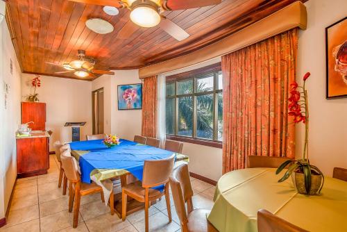 a dining room with a blue table and chairs at Hotel Casa Roland San Jose in San José