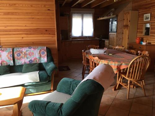 a kitchen and dining room with a table and chairs at 77 Rue de la Bresse in Nance