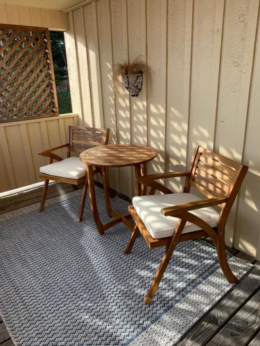 two chairs and a table on a porch at Kingfish at West Sound in Eastsound
