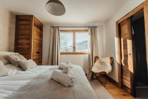 a bedroom with two beds and a window at Le Refuge des Anges in Megève