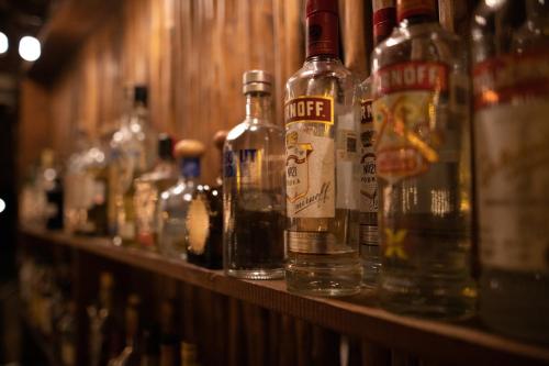 a row of bottles of alcohol on a shelf at HOTEL & BEACH CLUB OJO DE AGUA in Puerto Morelos