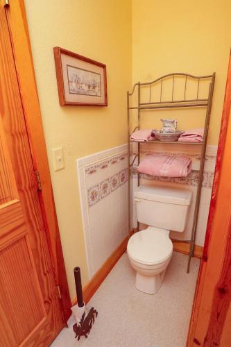 a bathroom with a white toilet in a room at Mickelson Trail Treehouse Suite in the heart of the beautiful Black Hills in Hill City