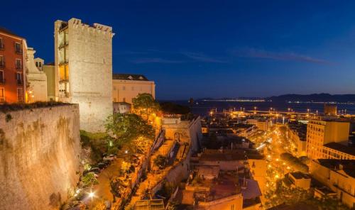a city at night with a castle and street lights at La Casetta in Quartu SantʼElena