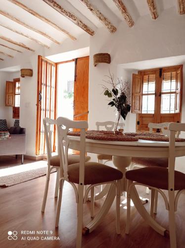 a dining room with a table and two chairs at La Casita Tipica in Zuheros