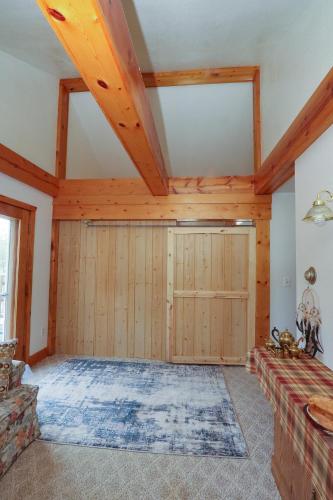 a large room with wooden walls and a large door at Mickelson Trail Treehouse Suite in the heart of the beautiful Black Hills in Hill City