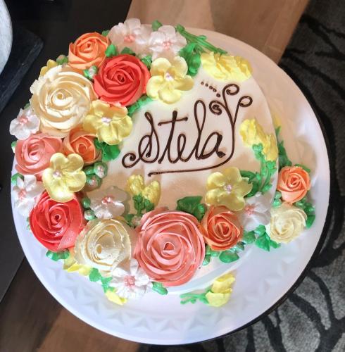 a birthday cake with roses on a white plate at Hotel Germânia in Joinville