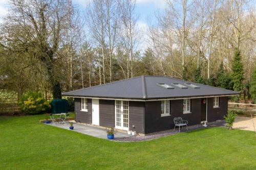 a tiny house with a pitched roof at Breckland Cottage - Secluded Country Getaway in Hockwold cum Wilton