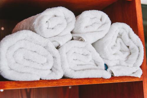 a bunch of towels on a wooden shelf at The Bulls Head in Milnthorpe
