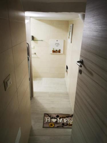 a bathroom with a walk in shower and a door at AP Apartment - in centro! in Gallipoli