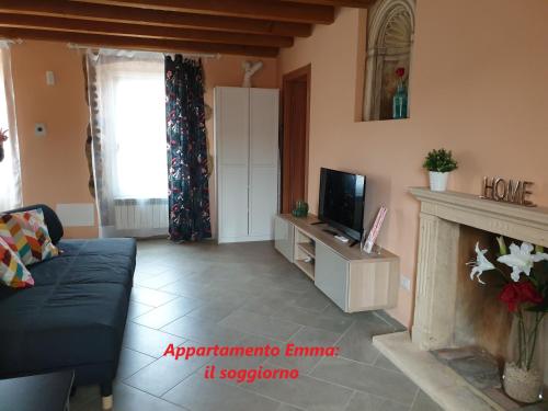 a living room with a tv and a fireplace at La casa di Edone in Monzambano