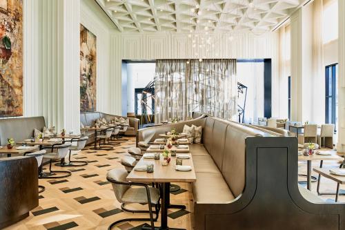 a restaurant with tables and chairs in a room at Daxton Hotel Birmingham, Curio Collection by Hilton in Birmingham