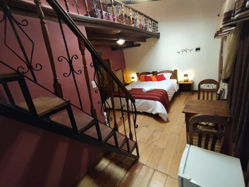 A bed or beds in a room at Patio de Piedra Hotel Boutique