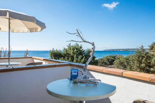 a blue table with a tree on top of it at Sol y Mar in Playa Migjorn