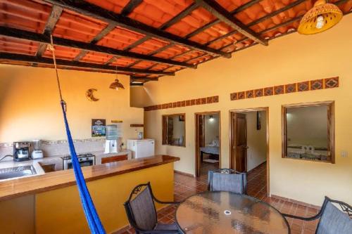 a dining room with a table and a kitchen at Casas Garcia in Yelapa