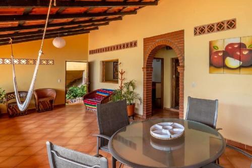 a dining room with a glass table and chairs at Casas Garcia in Yelapa