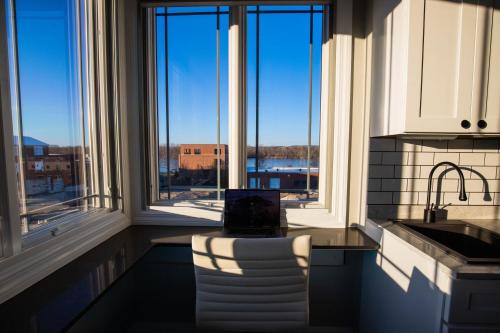 a kitchen with large windows and a view of the water at River Sirens Hotel-Contactless Check in Hotel in Washington