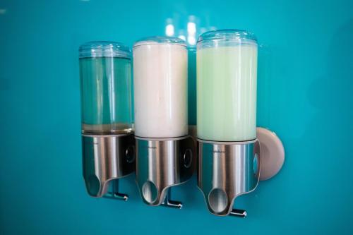 a blender filled with milk on a blue background at River Sirens Hotel-Contactless Check in Hotel in Washington