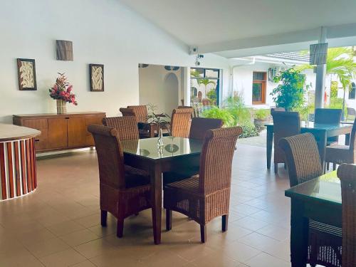 a dining room with a table and chairs at Sun Properties and Resort Hotel in Beau Vallon