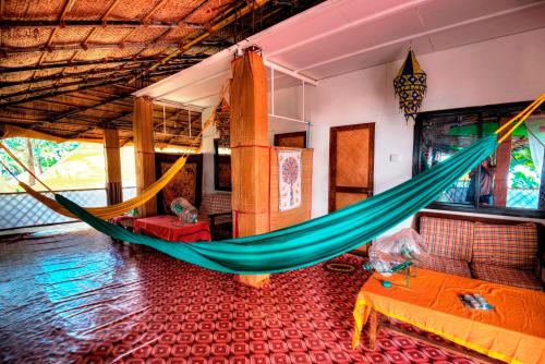 a room with a hammock in a room at Secret Garden in Agonda