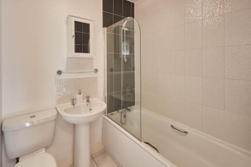 a bathroom with a sink and a toilet and a shower at Host & Stay - 57 Woodland View in Holmfirth