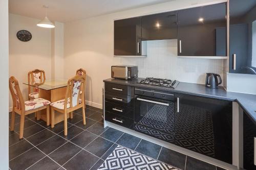 a kitchen with a table and a stove top oven at Host & Stay - 57 Woodland View in Holmfirth