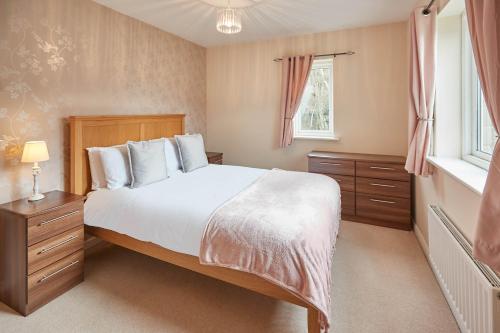 a bedroom with a large bed and a window at Host & Stay - 57 Woodland View in Holmfirth